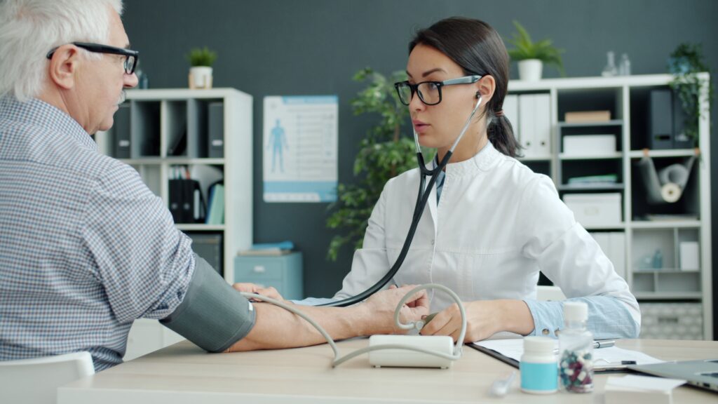 Healthcare services in Bangalore with a doctor checking a patient's blood pressure